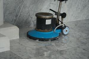 Floor Polishing Machine on Shiny Marble Floor for Cleaning and Maintenance photo