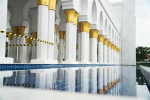 Elegant Islamic Inspired Architecture with Reflections and Golden Details photo