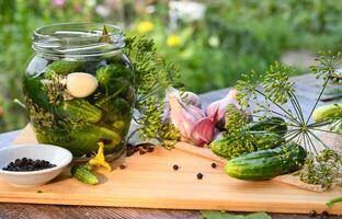 a set of ingredients for pickling cucumbers, pickled cucumbers, brine On a beautiful day. photo
