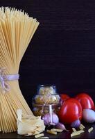 An overhead shot of a cluster of uncooked spaghetti, with a radial arrangement of strands. photo