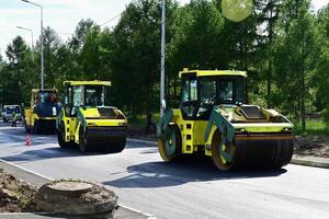 Large view on the road rollers working on the construction siteon a shunny day photo