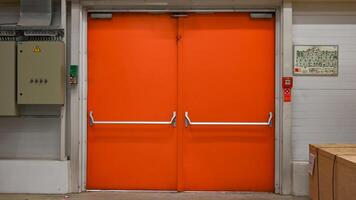 The evacuation exit is orange in the store. photo