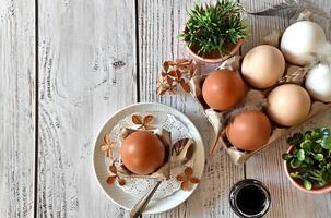 he image is rich in textures, from the smooth surface of the eggs to the delicate petals of the flowers to the crinkled paper in the bowl. photo