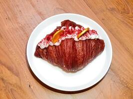 Red Croissant for Chinese New Year, Lunar New Year food, topped with golden coins fortune. photo