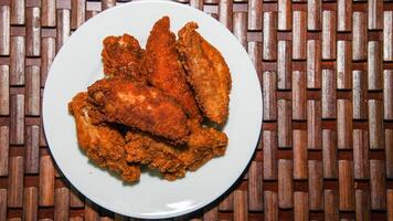 Crispy Fried Chicken Drumsticks Served on a White Plate View from above photo