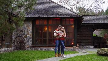 Romantic couple in the yard. Young guy and his girlfriend having a date on terrace in warm autumn day. Lovely couple stands at front yard of cottage. video