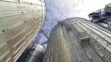 Industrial grain dryer. Modern complex for storage and further processing of grain. Large silos for keeping agricultural harvest. Close-up. video