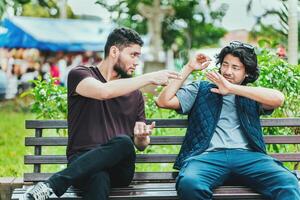 Young man sitting refusing a cigarette in the park. Disgusted guy sitting refusing a cigarette photo
