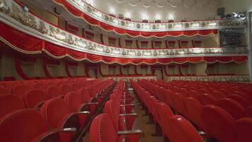 Beautiful vacant theater. Large hall with comfortable red armchairs without audience or crowd. Empty seats in a modern opera house. Closed place or venue. video