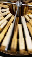 Centrifuge inside a metal barrel rotating and spinning honey frames. Extracting healthy product in special device. Vertical video
