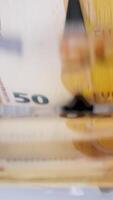 Euro currency on money counting machine. Electronic money counter machine is counting 50 euro banknotes. Automatic money counting machine. Vertical video