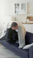 Happy man on bed. Young man waking up and began to joy waving blanket. Cheerful man recovered from the disease. Healthcare concept. Vertical video