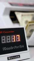 Electronic device showing the amount of money. Equipment for counting money. Money are counted in a calculating machine. Automatic equipment for banking financial transactions. Vertical video