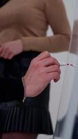 Young businessman writing on a whiteboard. Man and beautiful woman making new business plan and write the results on a board with a marker. Vertical video