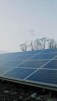 Photovoltaic solar panel at sunlight. Big blue sunny battery on the field generates clean energy. Alternative source of ecological energy. Vertical video