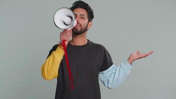 Man talking with megaphone, proclaiming news, loudly announcing advertisement pointing empty place video