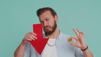 Upset man showing red arrow pointing down, fall of cryptocurrency stock market, mining bitcoins BTC video
