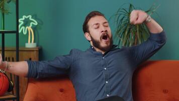 Tired lebanese man lying down on comfortable couch taking a rest daytime nap relaxing falling asleep video