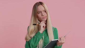 Woman making notes, writing down thoughts with pen into notepad notebook diary to do list, good idea video