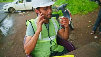 Engineer speaks in mobile discussing worksheet video