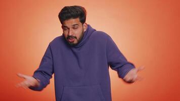 Puzzled clueless uncertain man raising hands in helpless, embarrassed confused by difficult question video