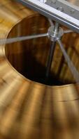 Fresh organic honey being extracted from wooden frames. Centrifuge machine rotating quickly for harvesting honey at apiary. Vertical video