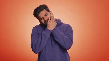 Man touching cheek suffering from toothache cavities or gingivitis waiting for dentist appointment video