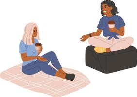 Two diverse young female friends holding disposable coffee cups talking and smiling while sitting on a blanket and a pouf, enjoying their free time, isolated on white background vector