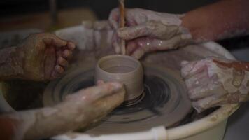 Clay bowl on pottery wheel made by master and apprentice video