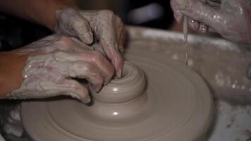A bowl is created on a potter's wheel and centered video