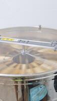 Electric device for extracting honey from frames. Centrifuge with frames rotating inside the metal barrel. Vertical video