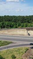 Asphalt road under construction. Aerial view aboveroad construction worker, view from drone Vertical video