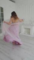 Classical young gourgeous bride. View of young smiling bride dancing in studio room Vertical video