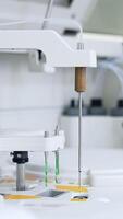 Some parts of modern equipment moving and carrying the blood test. Advanced technological appliances for science test and analysis. Vertical video