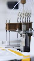 Device parts are moving going up and down. Close up. Technological equipment working in the advanced laboratory for medical testing. Vertical video