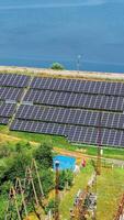 Solar panels in aerial view. Top view of solar panels in solar farm, view from the drone. New ecological kind of energy concept Vertical video