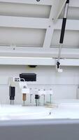 Large laboratory machine working and producing biomedical testing of blood. Advanced innovative equipment in science lab. Vertical video