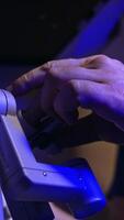 Surgery specialist operating innovative robotic equipment. Doctor looks into special binoculars and moves the handles. Close up. Low angle view. Vertical video