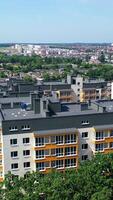 Modern residential building. View from the drone of the beautiful design of a new city complex. High-rise complex of apartment buildings with windows and balconies Vertical video