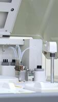 Modern healthcare testing analysis carried with the help of innovative equipment. Machine working at biomedical laboratory in present day hospital. Vertical video