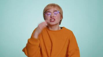 Woman showing a little bit gesture with sceptic smile showing minimum sign measuring small size video