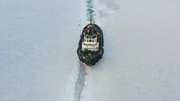Drone view of the tug from the front making its way through the ice at sunset video