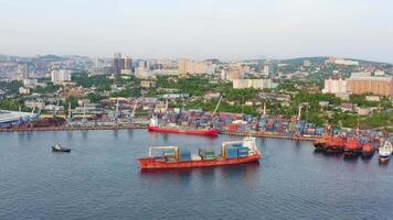 A cargo container ship slowly sailing in the dark waters. Drone view video