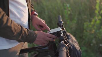Bike computer navigator. Modern technology. Bicycle handlebar with global positioning system. Cyclist checking cycling computer during trip. Route planning on GPS device and viewing offline maps. video