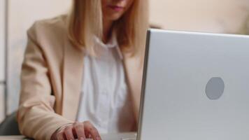 Business woman freelancer at office workplace desk working on laptop computer sends online messages video