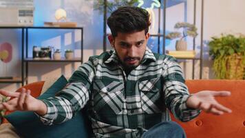 Upset indian man making face palm gesture, feeling bored, disappointed in fail bad results news video