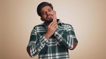 Man touching cheek suffering from toothache cavities or gingivitis waiting for dentist appointment video