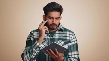 Man making notes, writing down thoughts with pen into notepad notebook diary, to do list, good idea video