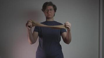 A woman puts on a compression sleeve on her arm to support vein health and prevent thrombosis. Compression helps improve circulation, reducing the risk of blood clots, varicose veins, and embolism. video