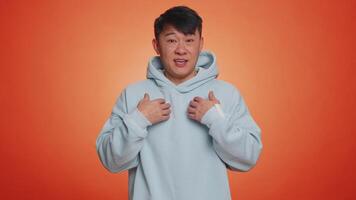 Man pointing to camera and looking with playful happy expression, making choice, showing direction video